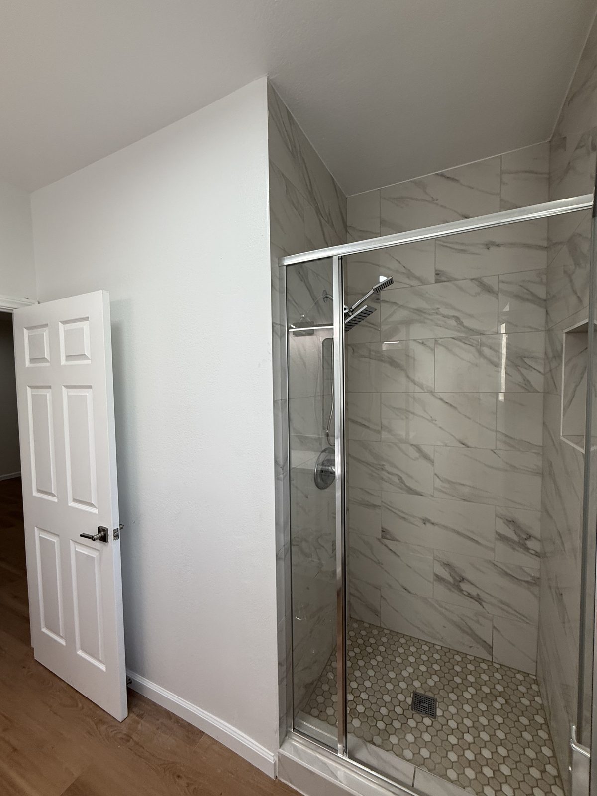 Finished walk-in shower with marble tile